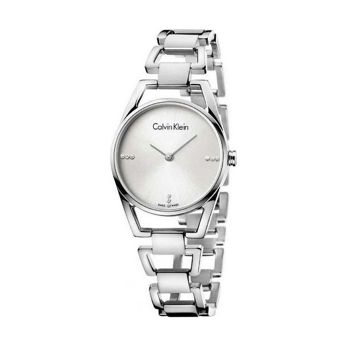 Montre femme Calvin Klein Dainty en acier poli argenté, cadran nacre blanc et cristaux éclatants, sur fond blanc pur, Maison Mercier.