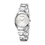 Montre femme Calvin Klein Dainty en acier poli argenté, cadran nacre blanc et cristaux éclatants, sur fond blanc pur, Maison Mercier.