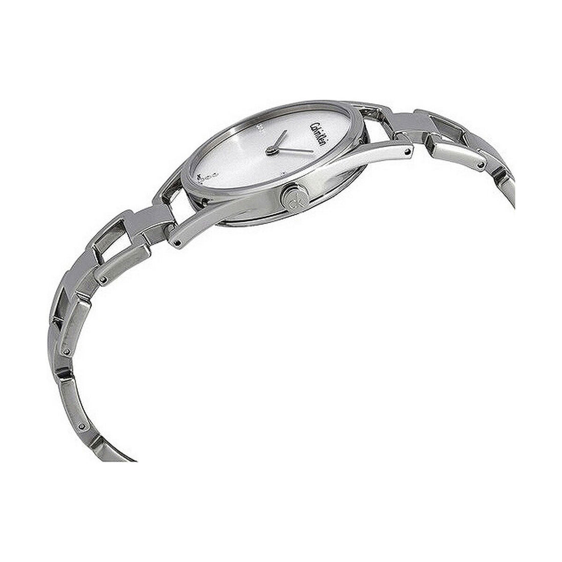 Montre femme Calvin Klein Dainty en acier poli argenté, cadran nacre blanc et cristaux éclatants, sur fond blanc pur, Maison Mercier.