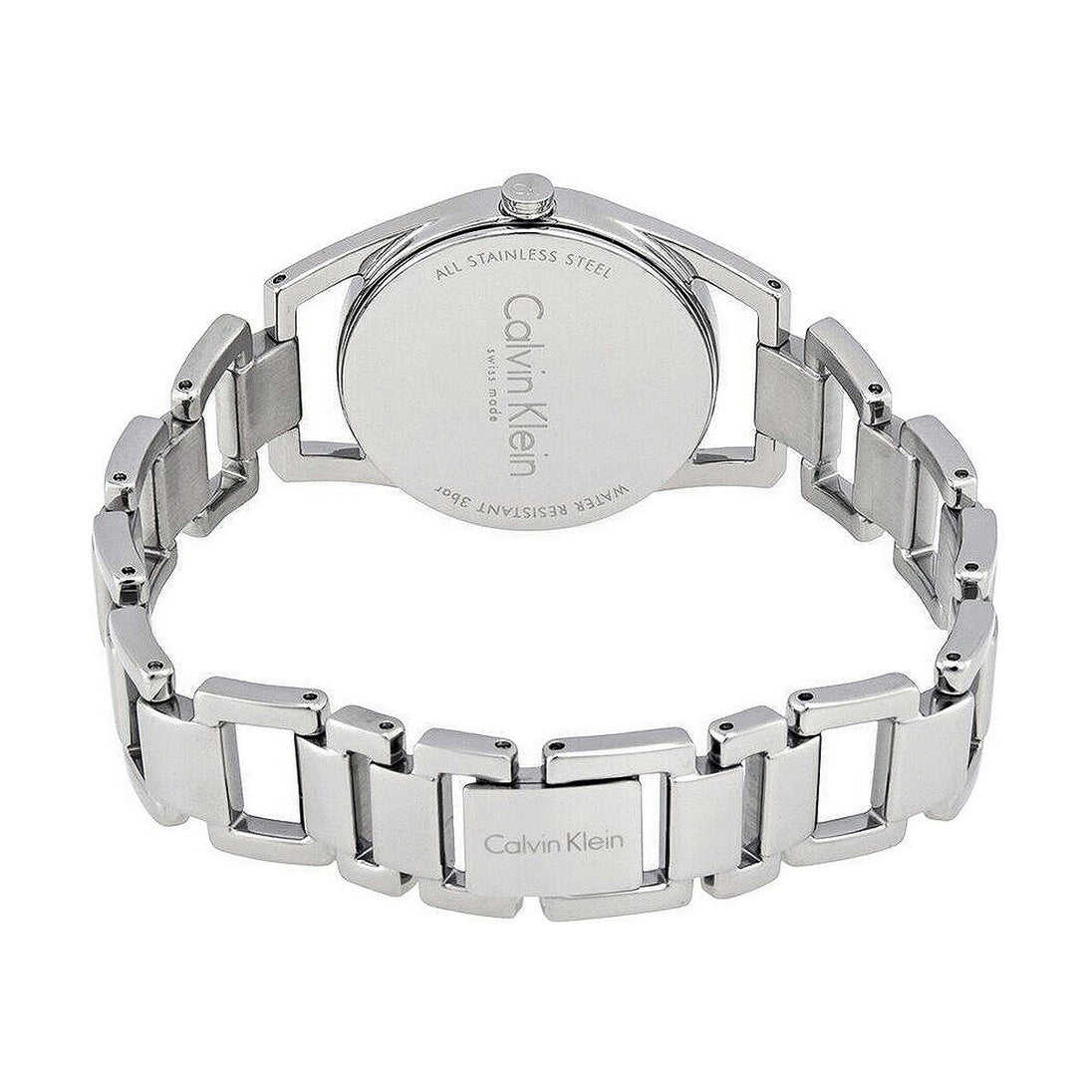 Montre femme Calvin Klein Dainty en acier poli argenté, cadran nacre blanc et cristaux éclatants, sur fond blanc pur, Maison Mercier.