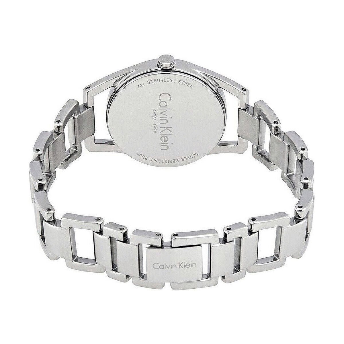 Montre femme Calvin Klein Dainty en acier poli argenté, cadran nacre blanc et cristaux éclatants, sur fond blanc pur, Maison Mercier.