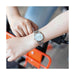 Montre femme Calvin Klein Dainty en acier poli argenté, cadran nacre blanc et cristaux éclatants, sur fond blanc pur, Maison Mercier.