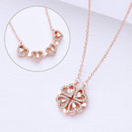 Collier pendentif transformable cœurs trèfle en acier doré et zirconia, présenté ouvert en ligne de cœurs et fermé en trèfle, sur fond bleu profond, Maison Mercier.