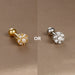 Collection de piercings d'oreille variés, en acier chirurgical doré et zircons, offrant une touche d'éclat discret, Maison Mercier.