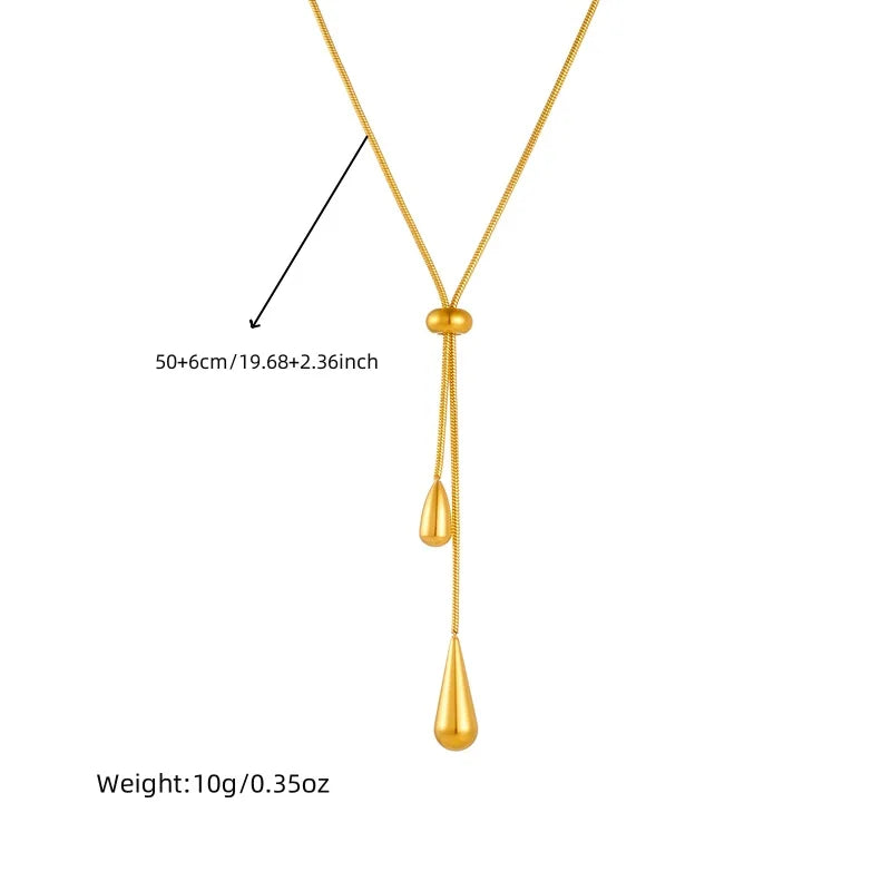 Détail du collier lariat Goutte d'Eau en acier doré, avec ses dimensions ajustables de 50+6 cm (19.68+2.36 inch) et un poids de 10g (0.35oz), Maison Mercier.