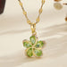 Vue d'ensemble de trois Colliers Pendentifs Floraux Maison Mercier, ornés de zircons blancs, verts et rouges, en acier doré.