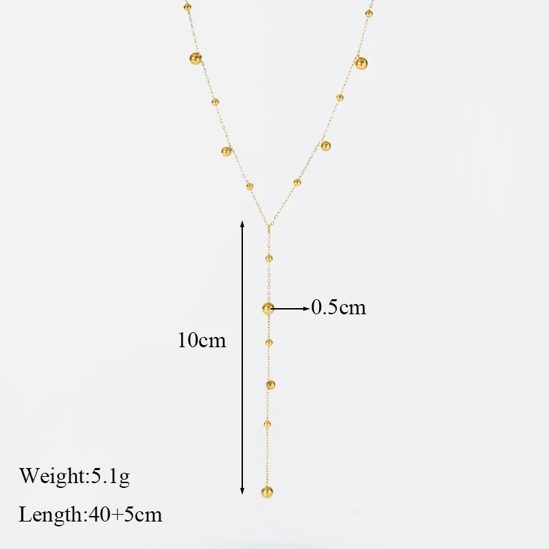 Vue détaillée du collier lariat Y doré avec ses perles, indiquant une longueur de chute de 10cm et un diamètre de perle de 0.5cm, poids 5.1g, longueur totale 40+5cm.