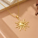 Détail d'un collier pendentif soleil rayonnant en acier inoxydable doré, présenté sur un écrin beige, Maison Mercier.