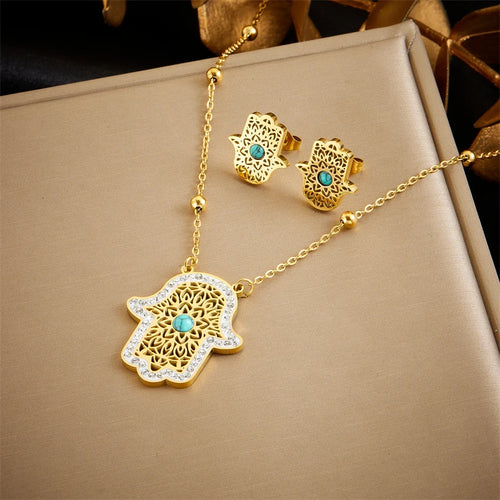 Détail d'une parure collier et puces d'oreilles serpent en acier doré, Maison Mercier.