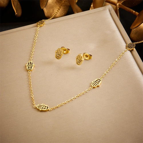 Détail d'une parure collier et puces d'oreilles serpent en acier doré, Maison Mercier.