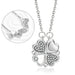 Collier pendentif transformable cœurs trèfle en acier doré et zirconia, présenté ouvert en ligne de cœurs et fermé en trèfle, sur fond bleu profond, Maison Mercier.