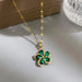 Vue d'ensemble de trois Colliers Pendentifs Floraux Maison Mercier, ornés de zircons blancs, verts et rouges, en acier doré.
