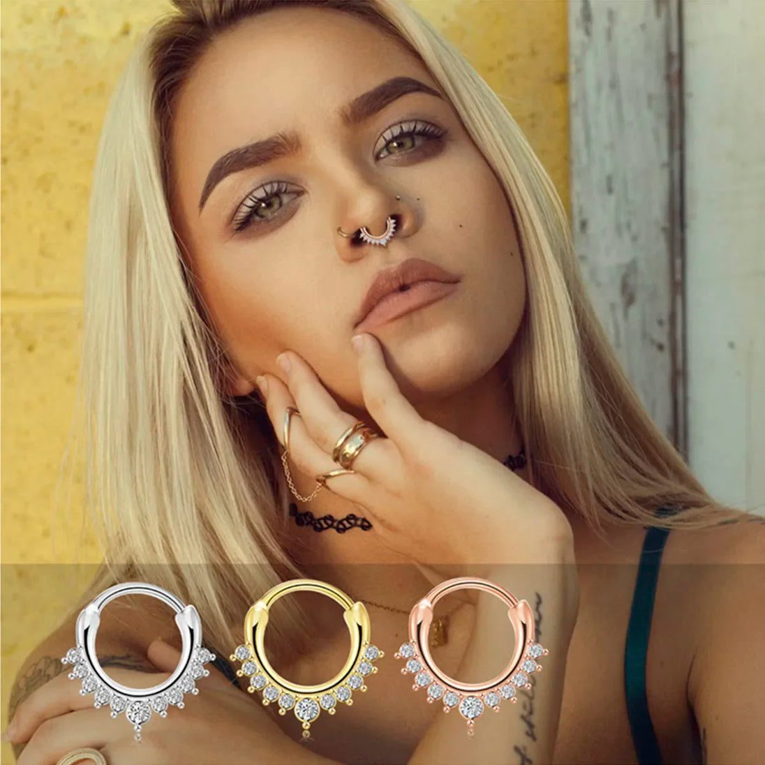 Gros plan sur un piercing clicker septum en acier chirurgical argenté orné de zircons taille marquise, avec un détail de goutte scintillante, Maison Mercier.