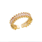 Assortiment de bagues ajustables dorées, chacune présentant un design distinct et une finition impeccable, Maison Mercier.