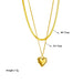 Collage de quatre créations Maison Mercier : un collier double chaîne avec pendentif rond noir, un collier chaîne gourmette avec pendentif cœur vert, un bracelet chaîne avec pendentif cœur et ovale noir, et un collier double chaîne avec étoiles et pendentif rectangulaire bleu.