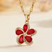 Vue d'ensemble de trois Colliers Pendentifs Floraux Maison Mercier, ornés de zircons blancs, verts et rouges, en acier doré.