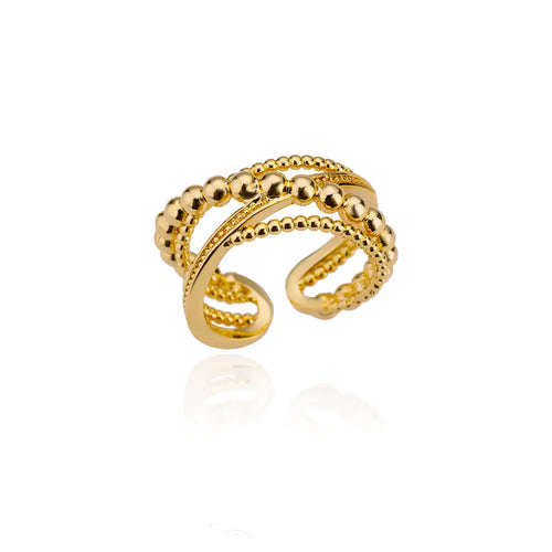 Bague large ajustable à motif cannelé ou strié en acier inoxydable doré poli, Maison Mercier.