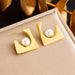 Paire de boucles d'oreilles puces sphériques polies en acier inoxydable doré, Maison Mercier.