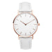 Montre féminine Maison Mercier, cadran noir épuré, bracelet maille milanaise finition or rose, portée au poignet avec un bracelet délicat à perles dorées.